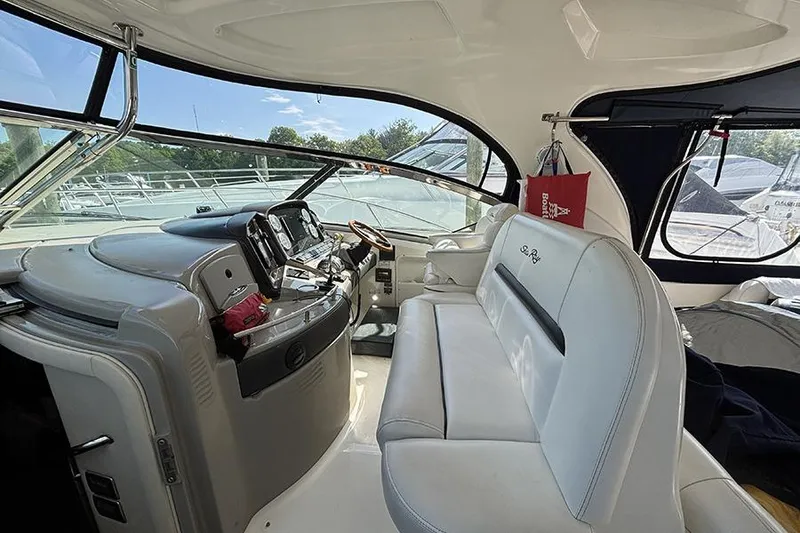 Slide: The Image of Interior view of 2006 Sea Ray 44 Sundancer yacht with white seating and control panel. - 10