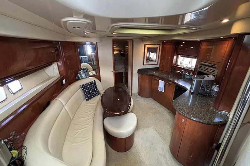 Slide: The Image of Luxurious interior of 2006 Sea Ray 44 Sundancer yacht with elegant seating and kitchen area. - 14
