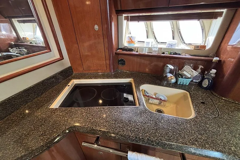 Slide: The Image of Luxurious 2006 Sea Ray 44 Sundancer yacht kitchen with granite countertops and modern appliances. - 15