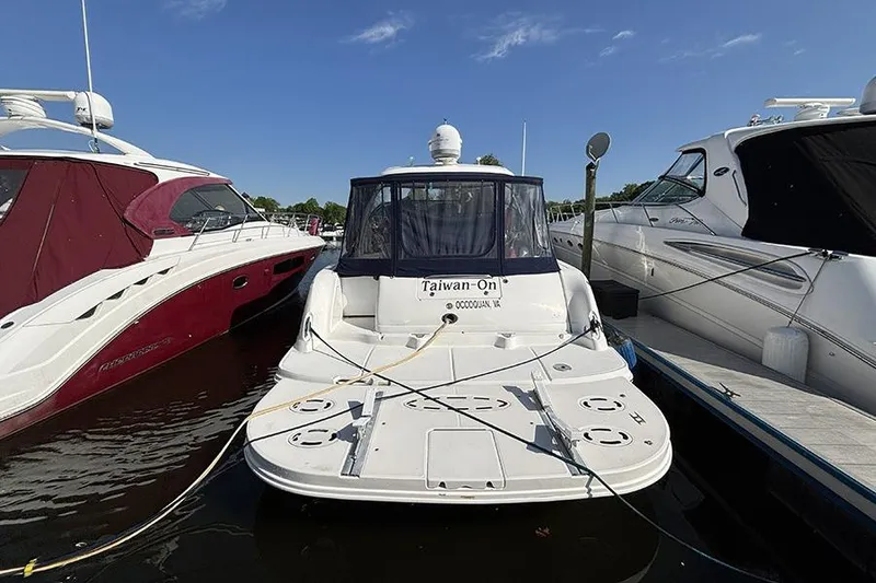 Slide: The Image of 2006 Sea Ray 44 Sundancer docked between two boats on a sunny day. - 2