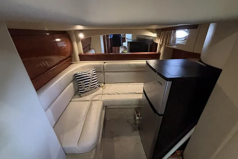 Slide: The Image of Interior of 2006 Sea Ray 44 Sundancer yacht with cozy seating and compact fridge. - 20