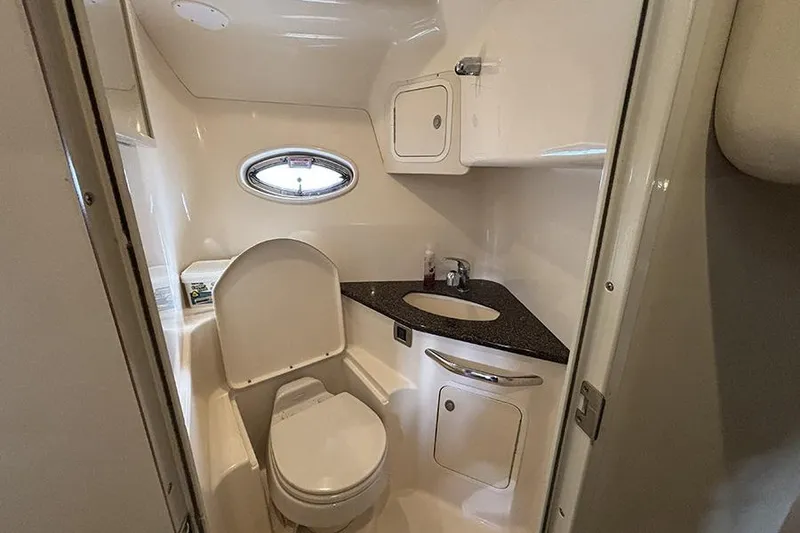 Slide: The Image of Bathroom interior of 2006 Sea Ray 44 Sundancer yacht, featuring compact design and porthole window. - 22