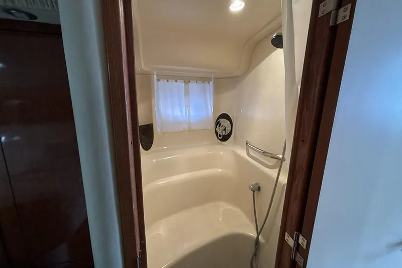 Slide: The Image of Shower area inside 2006 Sea Ray 44 Sundancer yacht, featuring sleek design and modern fixtures. - 27