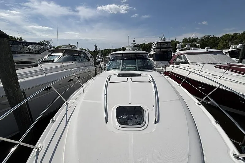 Slide: The Image of 2006 Sea Ray 44 Sundancer yacht docked among other boats under a clear sky. - 29