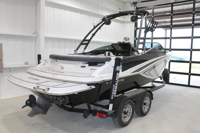 Slide: The Image of 2017 Glastron GT 205 boat on trailer in a garage setting. - 12