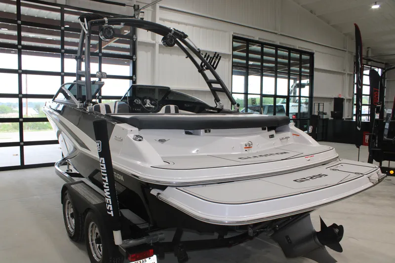 Slide: The Image of 2017 Glastron GT 205 boat in showroom, rear view with trailer. - 14