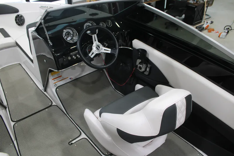 Slide: The Image of 2017 Glastron GT 205 boat interior with steering wheel and dashboard controls. - 6