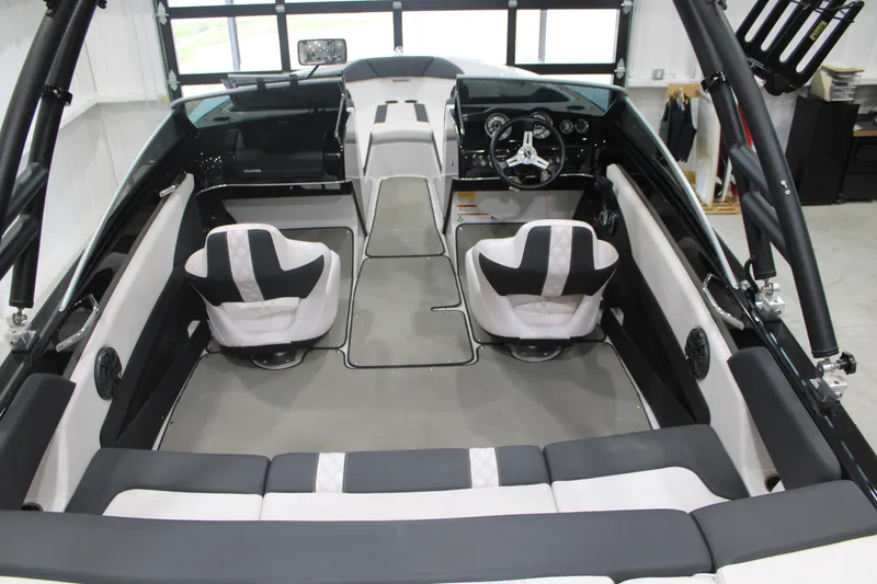 Slide: The Image of Interior of a 2017 Glastron GT 205 boat with modern seating and steering wheel. - 8