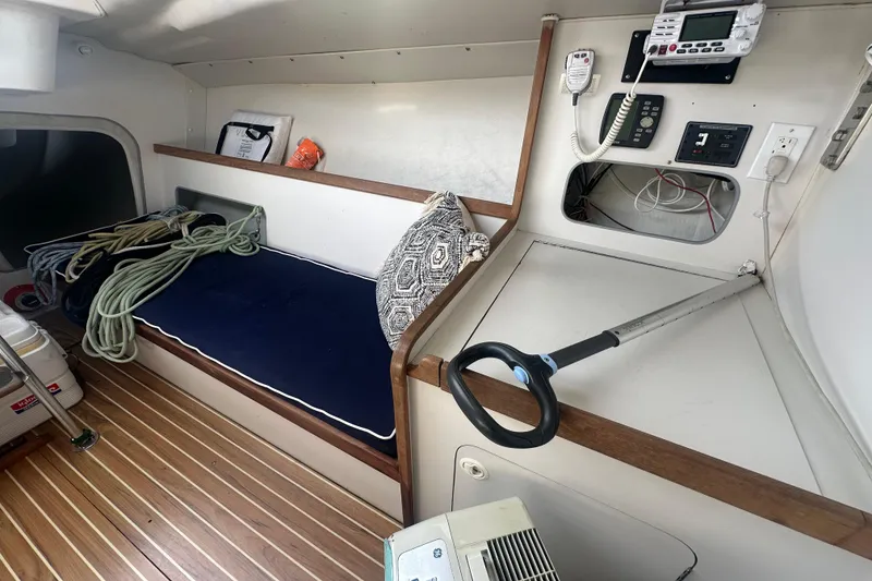Slide: The Image of Interior of a 1998 J Boats J/105 sailboat with seating, ropes, and navigation equipment. - 12