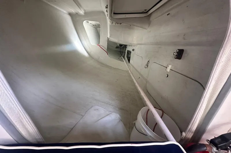 Slide: The Image of Interior view of a 1998 J Boats J/105 sailboat, showcasing storage space and equipment. - 14