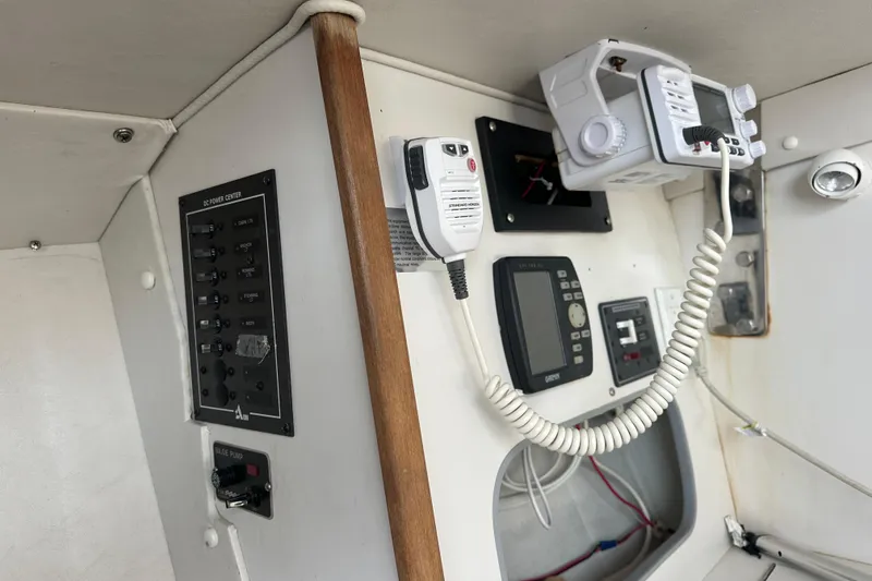 Slide: The Image of Interior view of a 1998 J Boats J/105 sailboat's control panel and communication equipment. - 15