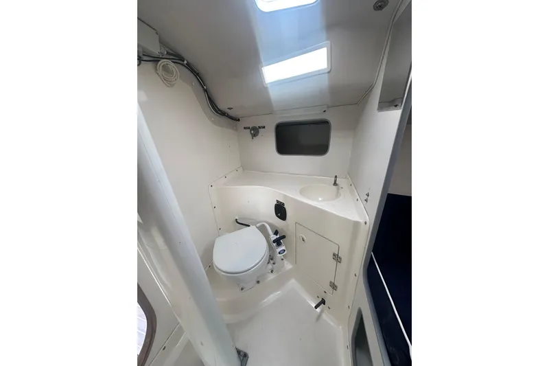 Slide: The Image of Interior of 1998 J Boats J/105 sailboat showing compact bathroom with toilet and sink. - 16