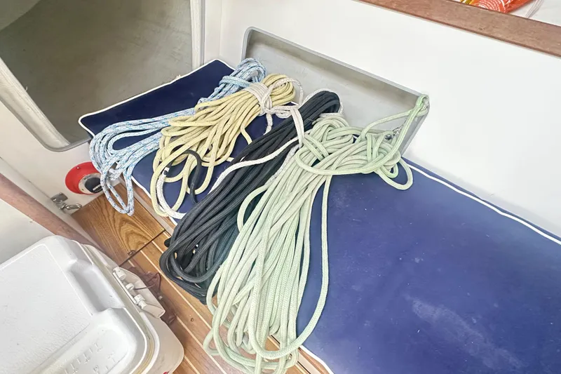 Slide: The Image of Coiled ropes on a 1998 J Boats J/105 sailboat interior bench. - 18