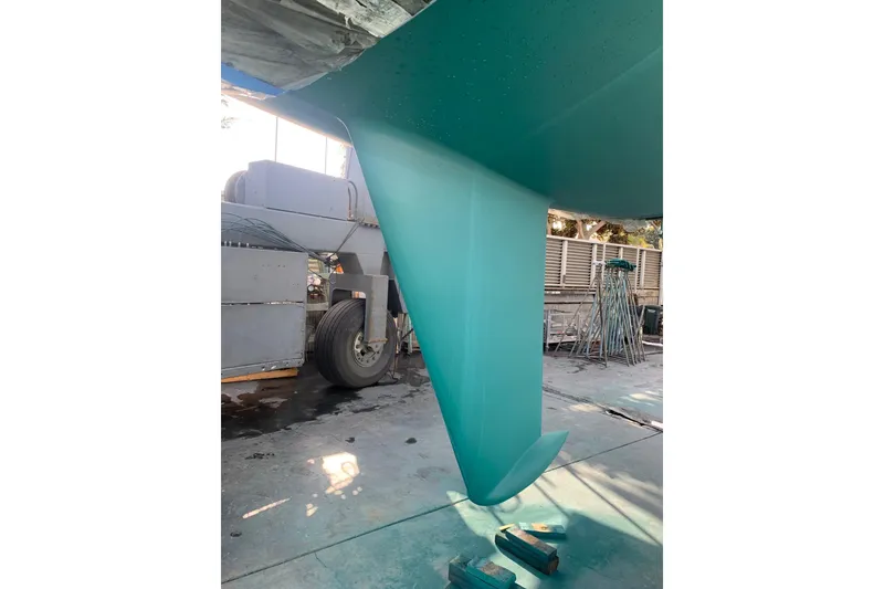 Slide: The Image of 1998 J Boats J/105 keel in a boatyard, showcasing sleek design and vibrant color. - 19