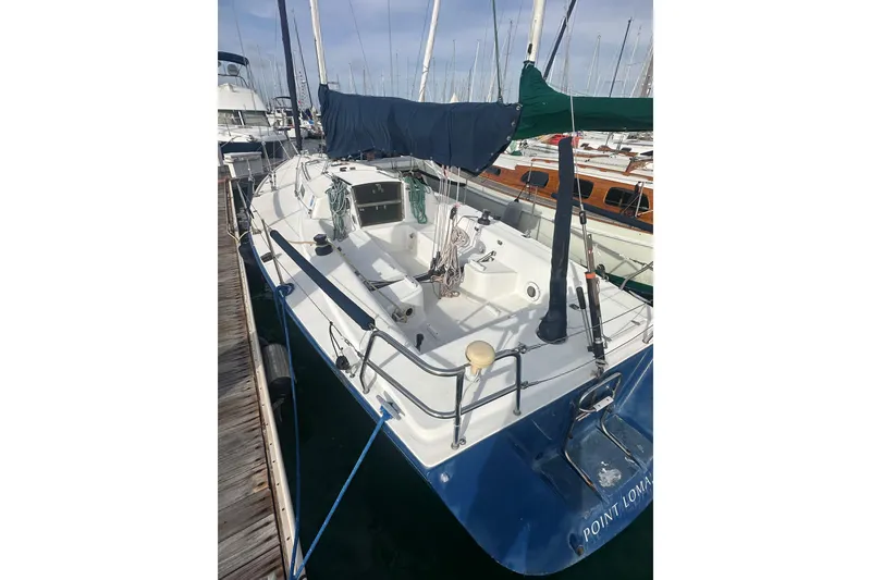 Slide: The Image of 1998 J Boats J/105 sailboat docked, featuring a clean deck and covered sails. - 23