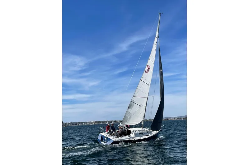 Slide: The Image of Sailing J Boats J/105, 1998 model, on open water under clear blue sky. - 3