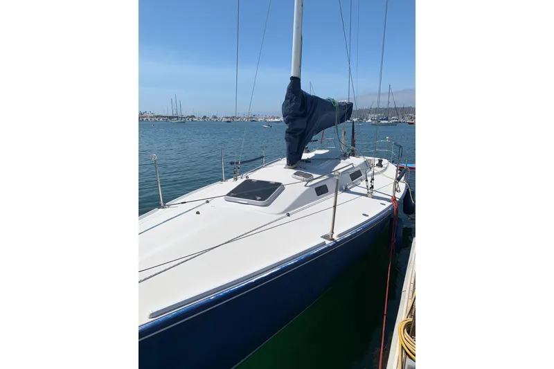 Slide: The Image of 1998 J Boats J/105 sailboat docked in a marina under clear blue skies. - 4