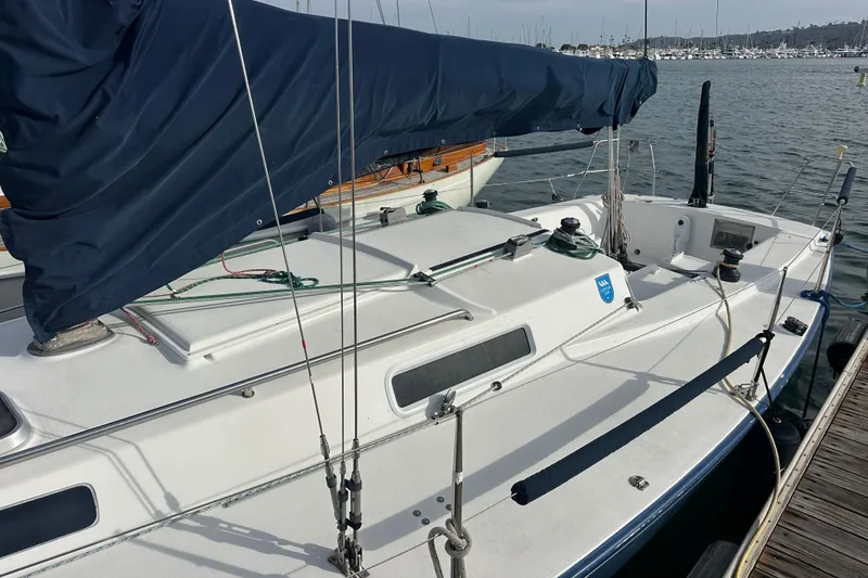 Slide: The Image of 1998 J Boats J/105 sailboat docked at marina, featuring covered mainsail. - 6