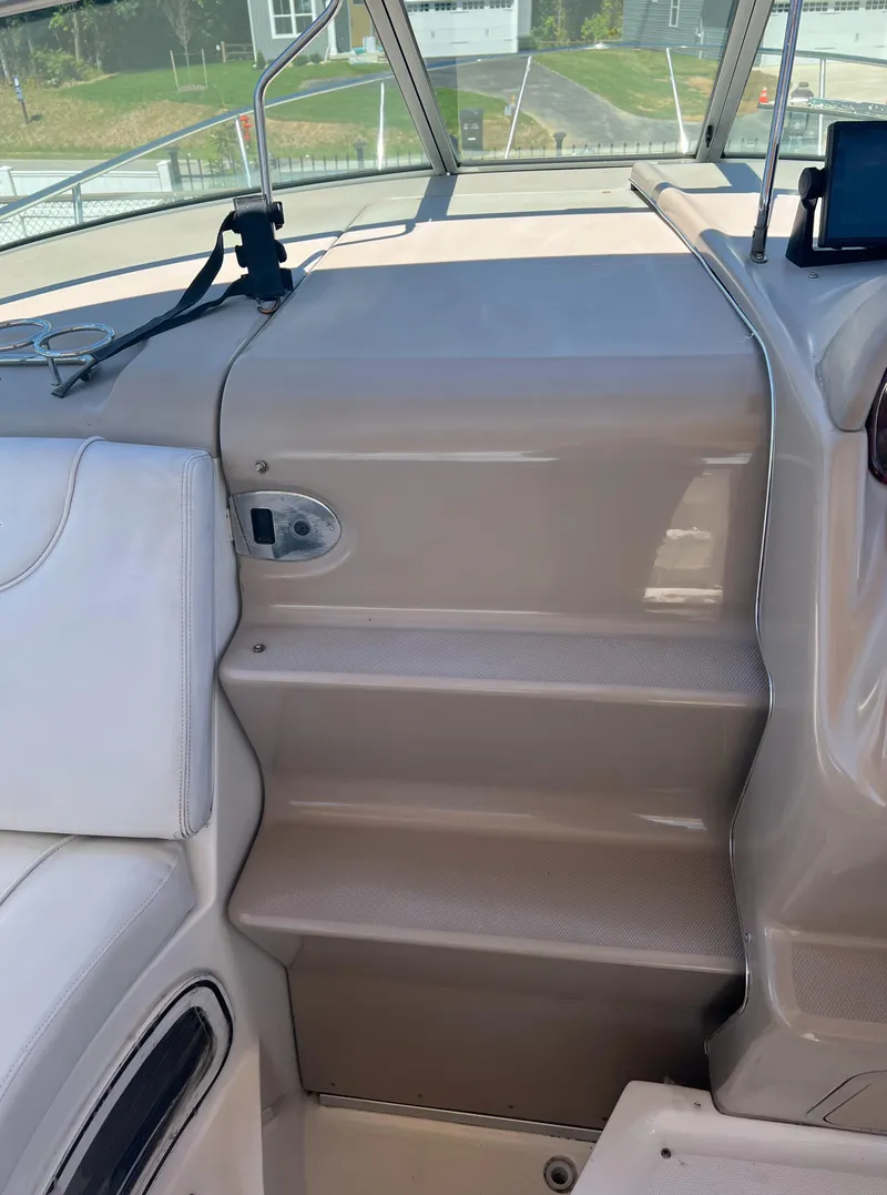 Slide: The Image of 2005 Sea Ray 280 Sundancer interior steps, beige finish, leading to cockpit area. - 27