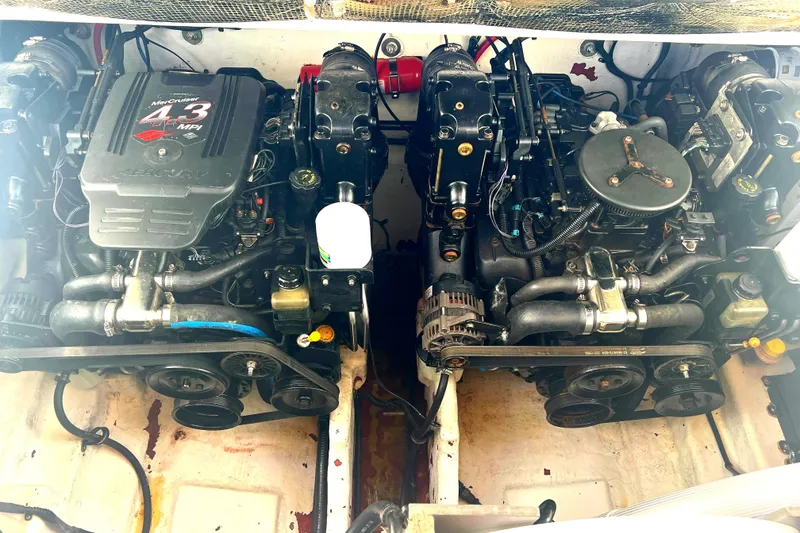 Slide: The Image of Twin engines of a 2005 Sea Ray 280 Sundancer boat, showcasing mechanical components. - 33