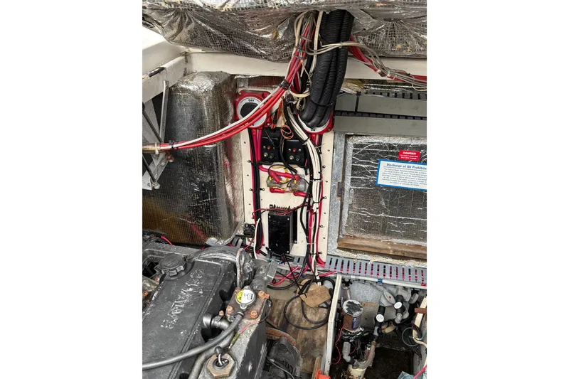 Slide: The Image of Engine compartment of a 1999 Luhrs Tournament 320 Open, showing wiring and components. - 13