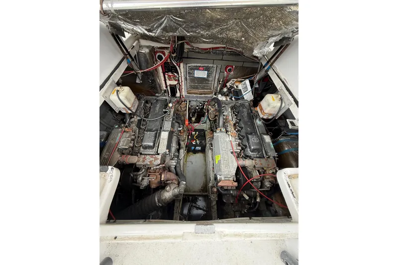 Slide: The Image of Engine compartment of a 1999 Luhrs Tournament 320 Open boat, showcasing dual engines. - 14