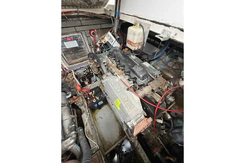 Slide: The Image of Engine compartment of a 1999 Luhrs Tournament 320 Open boat, showing detailed components. - 16
