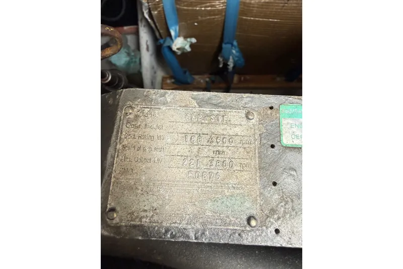 Slide: The Image of Close-up of a weathered engine plate on a 1999 Luhrs Tournament 320 Open boat. - 17