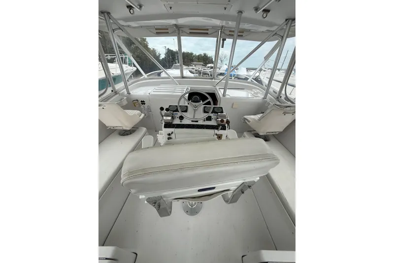 Slide: The Image of 1999 Luhrs Tournament 320 Open boat cockpit with steering wheel and seating. - 20