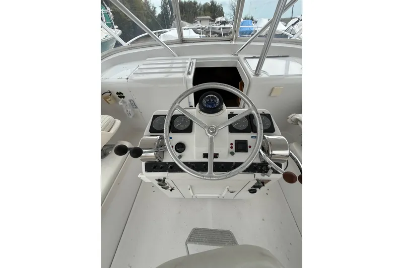 Slide: The Image of 1999 Luhrs Tournament 320 Open boat helm with steering wheel and navigation instruments. - 24