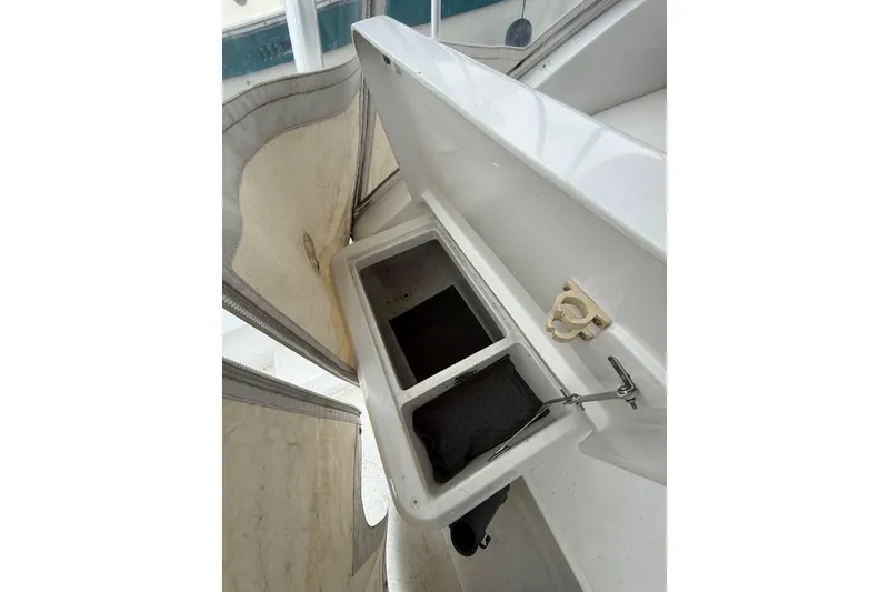 Slide: The Image of 1999 Luhrs Tournament 320 Open boat storage compartment with open hatch and canvas cover. - 25