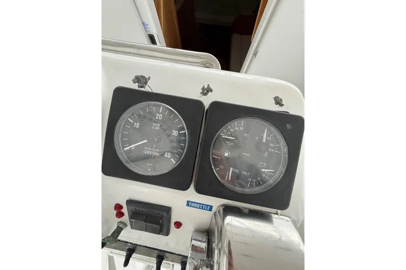 Slide: The Image of 1999 Luhrs Tournament 320 Open dashboard with RPM and fuel gauges. - 27