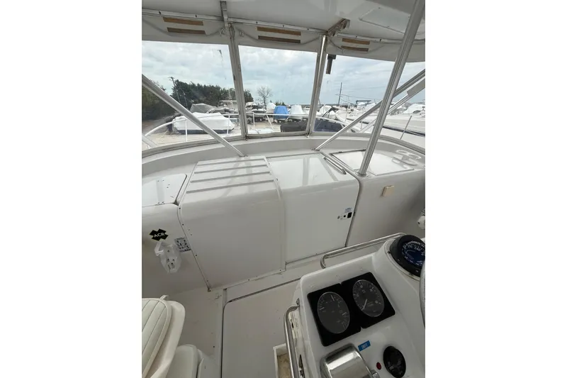Slide: The Image of 1999 Luhrs Tournament 320 Open boat interior with navigation instruments and seating. - 28