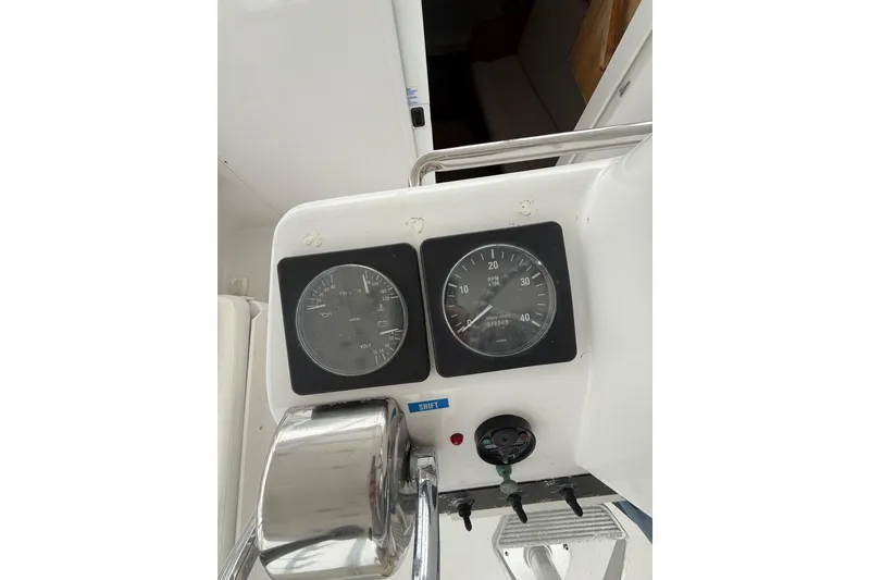 Slide: The Image of Control panel of a 1999 Luhrs Tournament 320 Open boat, featuring gauges and controls. - 29