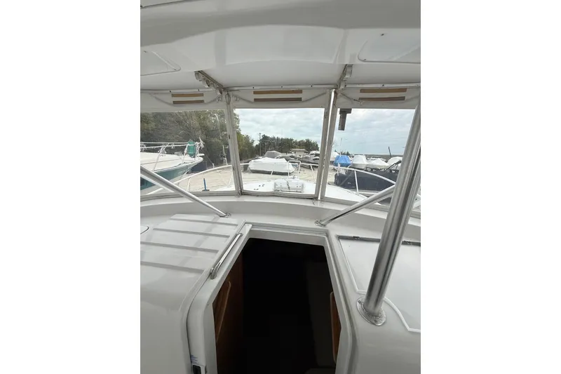 Slide: The Image of 1999 Luhrs Tournament 320 Open boat interior view with marina background. - 30