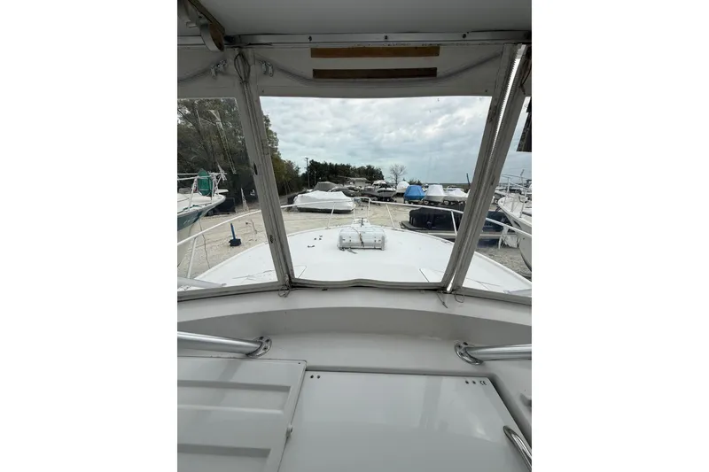 Slide: The Image of 1999 Luhrs Tournament 320 Open boat view from cockpit, docked among other boats. - 31
