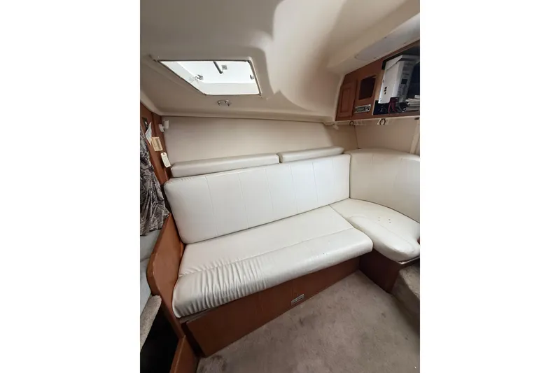 Slide: The Image of Interior of 1999 Luhrs Tournament 320 Open with white leather seating and overhead hatch. - 34