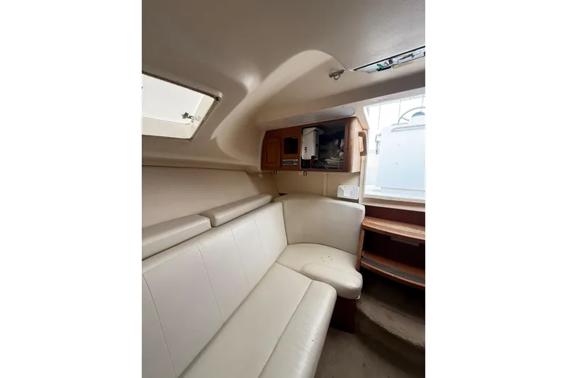 Slide: The Image of Interior of 1999 Luhrs Tournament 320 Open boat with white seating and wooden cabinetry. - 35