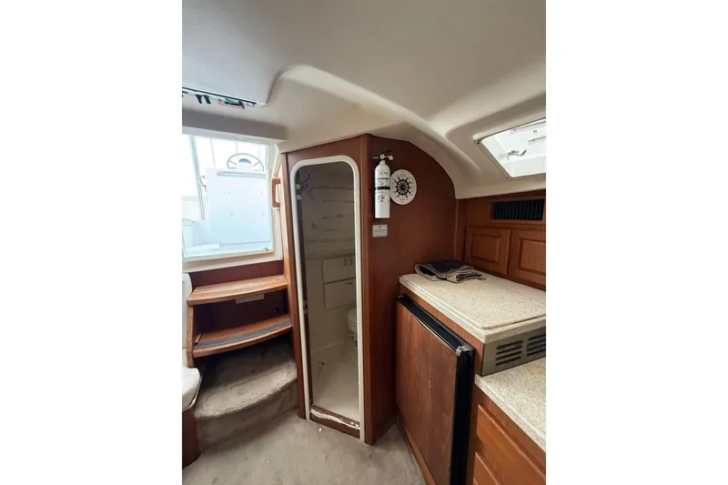 Slide: The Image of Interior of 1999 Luhrs Tournament 320 Open boat with kitchenette and storage. - 36