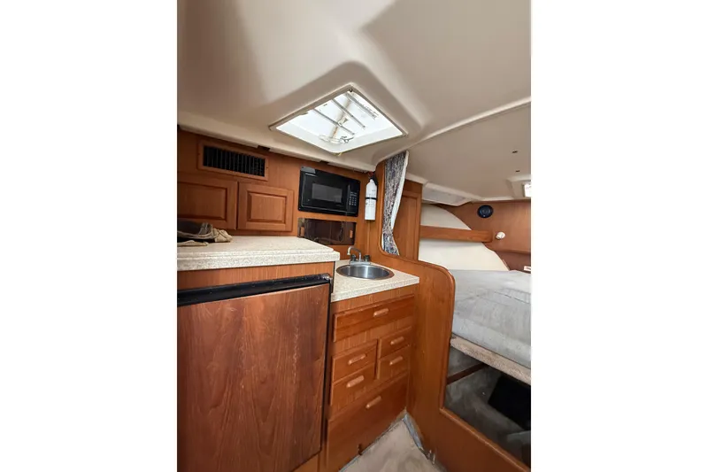 Slide: The Image of Interior of 1999 Luhrs Tournament 320 Open boat with kitchenette and sleeping area. - 38