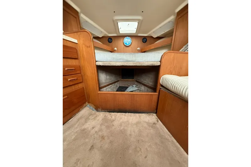 Slide: The Image of 1999 Luhrs Tournament 320 Open cabin interior with wood finish and seating area. - 39
