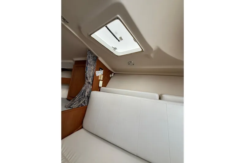 Slide: The Image of Interior of 1999 Luhrs Tournament 320 Open boat with white seating and overhead hatch. - 40