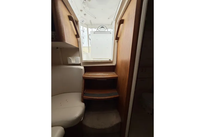Slide: The Image of Interior view of 1999 Luhrs Tournament 320 Open boat, featuring wooden steps and seating. - 42