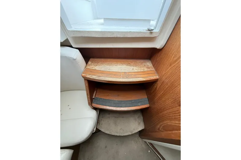 Slide: The Image of 1999 Luhrs Tournament 320 Open interior with wooden steps and white seating. - 46