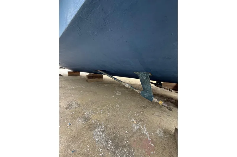 Slide: The Image of 1999 Luhrs Tournament 320 Open boat hull on dry dock, showing propeller shaft. - 5