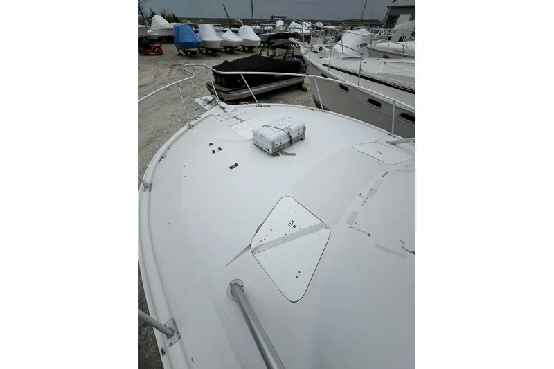 Slide: The Image of 1999 Luhrs Tournament 320 Open boat deck, docked among other vessels. - 51