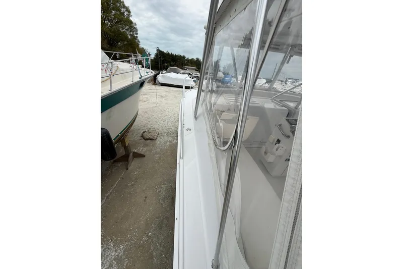 Slide: The Image of 1999 Luhrs Tournament 320 Open boat on dry dock, side view with clear enclosure. - 53