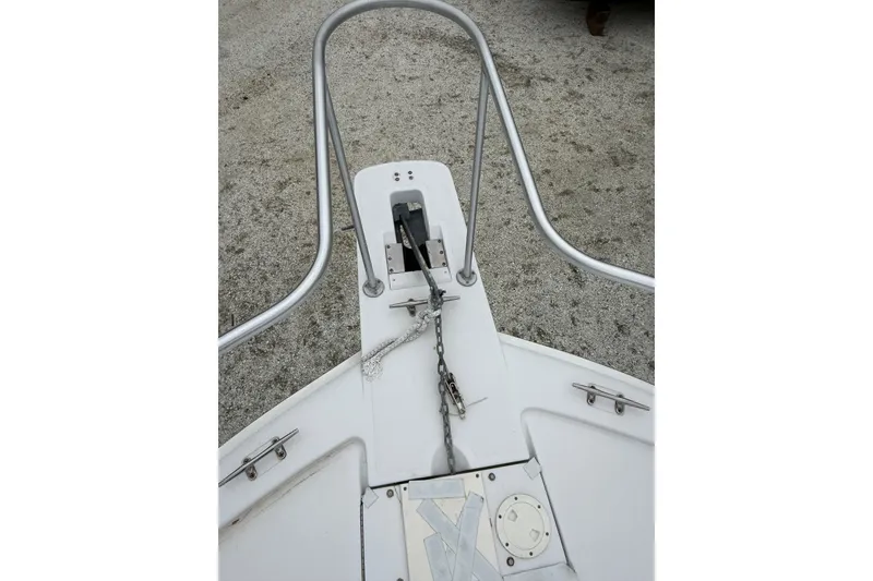 Slide: The Image of Bow of 1999 Luhrs Tournament 320 Open with anchor chain and railings. - 54