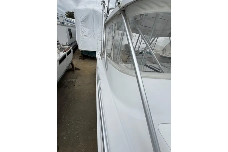 Slide: The Image of 1999 Luhrs Tournament 320 Open boat, side view with cockpit and railing details. - 57