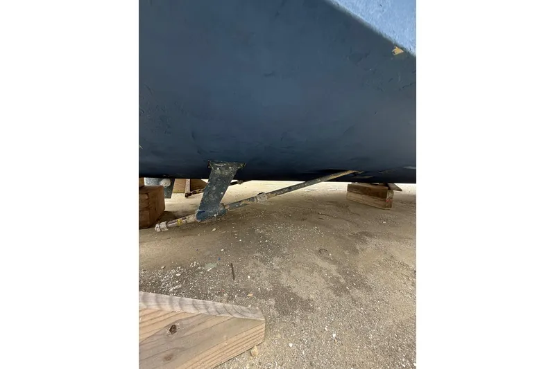 Slide: The Image of 1999 Luhrs Tournament 320 Open boat hull on wooden blocks, showing propeller shaft. - 6